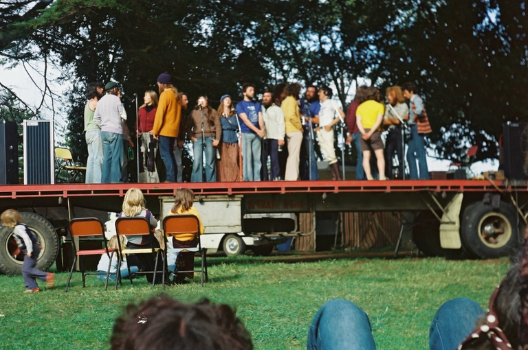 Vintage 1970s photo of folk musicians performing on a flatbed truck stage outdoors at the inaugural Port Fairy Folk Festival in Australia.